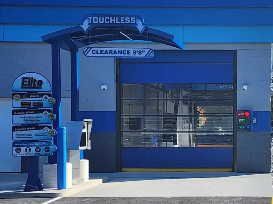 Elite Express Wash touchless bay with a 9 foot 8 inch clearance sign over the entrance